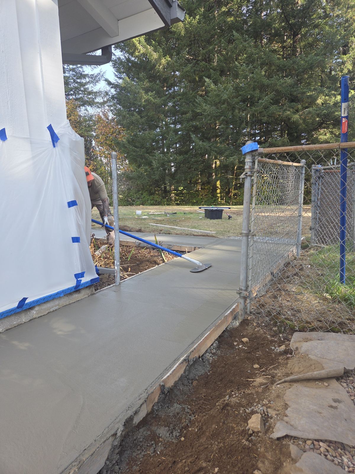 New concrete walkway along a house