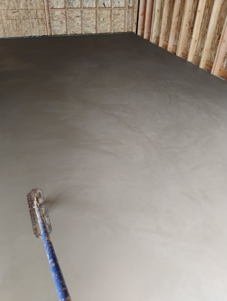 Troweling a fresh interior concrete floor