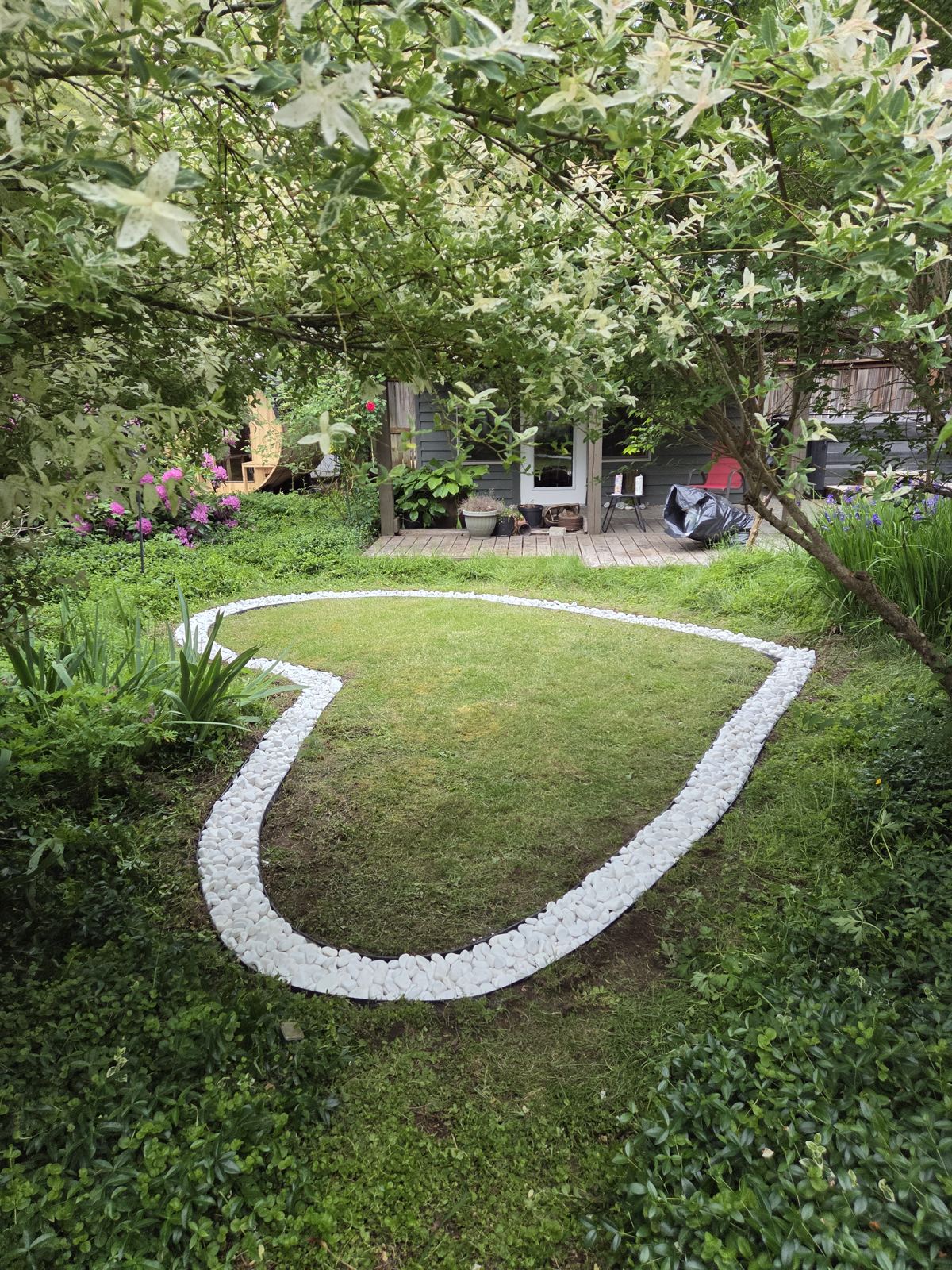 Close view of a heart-shaped white rock border in a lawn
