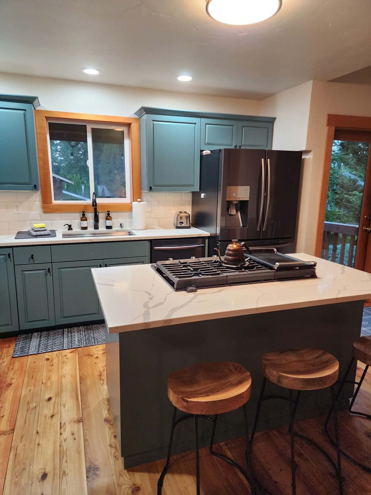 Modern green kitchen with island, cleaned and staged